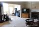 Spacious living room features neutral paint, plush carpet, fireplace, and adjacent dining and living areas at 8620 Rolling Fields Rd, Charlotte, NC 28227