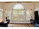 Bright living room features a large window, neutral paint, plush carpet, and stylish decor at 8620 Rolling Fields Rd, Charlotte, NC 28227