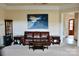 Spacious living room features neutral paint, plush carpet, large painting, and adjacent rooms at 8620 Rolling Fields Rd, Charlotte, NC 28227
