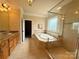 Bright main bathroom features double vanities, a garden tub, and a tiled walk-in shower at 8620 Rolling Fields Rd, Charlotte, NC 28227