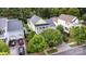 Aerial shot showcases the light green home, driveway, and nearby two-car garage at 9210 Ginhouse Ln, Charlotte, NC 28277
