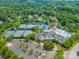 Aerial view of a community with tennis courts and a pool at 9210 Ginhouse Ln, Charlotte, NC 28277