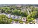 An aerial view highlights the neighborhood's mature trees and residential streets at 9210 Ginhouse Ln, Charlotte, NC 28277