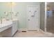 Bright bathroom featuring vanity with sink, linen closet, and glass-enclosed shower at 9210 Ginhouse Ln, Charlotte, NC 28277