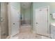 Bright bathroom featuring a shower, tub, and white doors at 9210 Ginhouse Ln, Charlotte, NC 28277