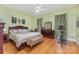 Primary bedroom features hardwood floors, and a ceiling fan at 9210 Ginhouse Ln, Charlotte, NC 28277