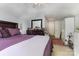 Bedroom featuring plush purple bedding, dresser, and closet for storage at 9210 Ginhouse Ln, Charlotte, NC 28277