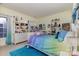 Bedroom features a rainbow blanket, shelves, and hardwood floors at 9210 Ginhouse Ln, Charlotte, NC 28277
