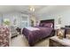 Cozy bedroom with ceiling fan, plush purple bedding, and complementary decor at 9210 Ginhouse Ln, Charlotte, NC 28277