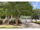 Beautiful light-green home featuring a welcoming front porch and a two-car garage at 9210 Ginhouse Ln, Charlotte, NC 28277