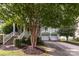 Inviting light-green home with a cozy front porch and two-car garage at 9210 Ginhouse Ln, Charlotte, NC 28277
