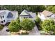 Aerial view of home with green paint, landscaping, and a welcoming front porch at 9210 Ginhouse Ln, Charlotte, NC 28277