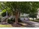 Charming home exterior with landscaped yard, front porch, and attached two-car garage at 9210 Ginhouse Ln, Charlotte, NC 28277