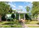 A light green home with a metal roof, a well manicured lawn, and sidewalk at 9210 Ginhouse Ln, Charlotte, NC 28277