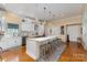 Bright kitchen with a large island, pendant lighting, and ample counter space at 9210 Ginhouse Ln, Charlotte, NC 28277