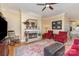 Cozy living room featuring a fireplace, hardwood floors, and ample seating at 9210 Ginhouse Ln, Charlotte, NC 28277