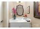 Charming powder room featuring a decorative mirror and modern fixtures at 9210 Ginhouse Ln, Charlotte, NC 28277
