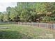 Large, grassy backyard is enclosed by a classic wood fence at 10726 Greenhead View Rd, Charlotte, NC 28262