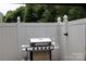 Enjoy outdoor cooking with this backyard grill and white privacy fence at 10726 Greenhead View Rd, Charlotte, NC 28262