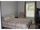 Cozy bedroom with a queen bed, neutral decor, and a window view at 10726 Greenhead View Rd, Charlotte, NC 28262