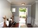 Inviting foyer with hardwood floors and decorative vases, leading to a beautifully landscaped front yard at 10726 Greenhead View Rd, Charlotte, NC 28262