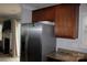 Bright kitchen featuring a stainless steel refrigerator and a view of the adjacent living area at 10726 Greenhead View Rd, Charlotte, NC 28262