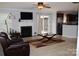 Open living room featuring a fireplace, ceiling fan, and seamless flow to the adjacent kitchen at 10726 Greenhead View Rd, Charlotte, NC 28262