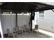 Shaded patio with metal chairs and a white privacy fence at 10726 Greenhead View Rd, Charlotte, NC 28262