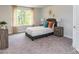 Bright bedroom features a comfortable bed, neutral tones, and a large window at 1090 Gardenia Dr # 5, Mt Ulla, NC 28125