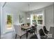 Bright dining area with a large window, a modern chandelier, and a table set for eight guests at 1090 Gardenia Dr # 5, Mt Ulla, NC 28125