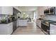 Stylish kitchen featuring white cabinets, granite countertops, stainless steel appliances, and open dining area at 1090 Gardenia Dr # 5, Mt Ulla, NC 28125