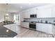 Modern kitchen featuring white cabinets, granite countertops, stainless steel appliances, and a center island at 1090 Gardenia Dr # 5, Mt Ulla, NC 28125