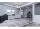 Open living area featuring a large window, elegant lighting, and views into the adjacent entryway at 1090 Gardenia Dr # 5, Mt Ulla, NC 28125