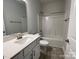 Bright full bathroom with white vanity, tub-shower combo, and gray plank flooring at 1110 Gardenia Dr # 6, Mt Ulla, NC 28125