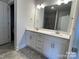 Bathroom features double vanity with white cabinets, granite countertop, and chrome fixtures at 1110 Gardenia Dr # 6, Mt Ulla, NC 28125