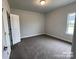 Bedroom with neutral walls, carpeted floors, and a double-door closet at 1110 Gardenia Dr # 6, Mt Ulla, NC 28125