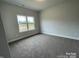 Carpeted bedroom with natural light from a large window overlooks the neighborhood at 1110 Gardenia Dr # 6, Mt Ulla, NC 28125