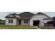 New single-story home featuring a classic roofline and large windows in a partially constructed community at 1110 Gardenia Dr # 6, Mt Ulla, NC 28125
