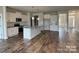 Bright, spacious kitchen featuring stainless steel appliances, a center island, and stylish wood flooring at 1110 Gardenia Dr # 6, Mt Ulla, NC 28125