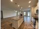 Open-concept kitchen boasts a large island with countertops, modern appliances, and wood flooring at 1110 Gardenia Dr # 6, Mt Ulla, NC 28125