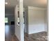 Open-concept living area with decorative molding, a view of fireplace and hard wood flooring at 1110 Gardenia Dr # 6, Mt Ulla, NC 28125