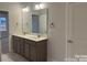 This bathroom features double sinks, modern fixtures and stylish gray cabinets at 1130 Gardenia Dr # 7, Mt Ulla, NC 28125