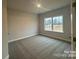 Spacious bedroom with carpet flooring and a window providing natural light at 1130 Gardenia Dr # 7, Mt Ulla, NC 28125