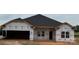 Unfinished exterior elevation featuring a large garage and newly installed roof at 1130 Gardenia Dr # 7, Mt Ulla, NC 28125