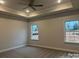A spacious main bedroom features two windows that lets in natural light and neutral walls and carpet at 1130 Gardenia Dr # 7, Mt Ulla, NC 28125