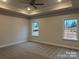 A spacious main bedroom features two windows that lets in natural light and neutral walls and carpet at 1130 Gardenia Dr # 7, Mt Ulla, NC 28125