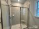 Tiled shower with glass doors, built-in seat, and modern fixtures, providing a spa-like experience at 1130 Gardenia Dr # 7, Mt Ulla, NC 28125