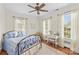 Cozy bedroom with hardwood floors, a ceiling fan, and abundant natural light at 117 N Mulberry St, Statesville, NC 28677