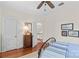 Bedroom featuring hardwood floors, neutral walls, and a view to the staircase at 117 N Mulberry St, Statesville, NC 28677