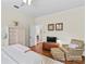 Bright, inviting bedroom with wood floors, a comfortable chair, and ample natural light at 117 N Mulberry St, Statesville, NC 28677